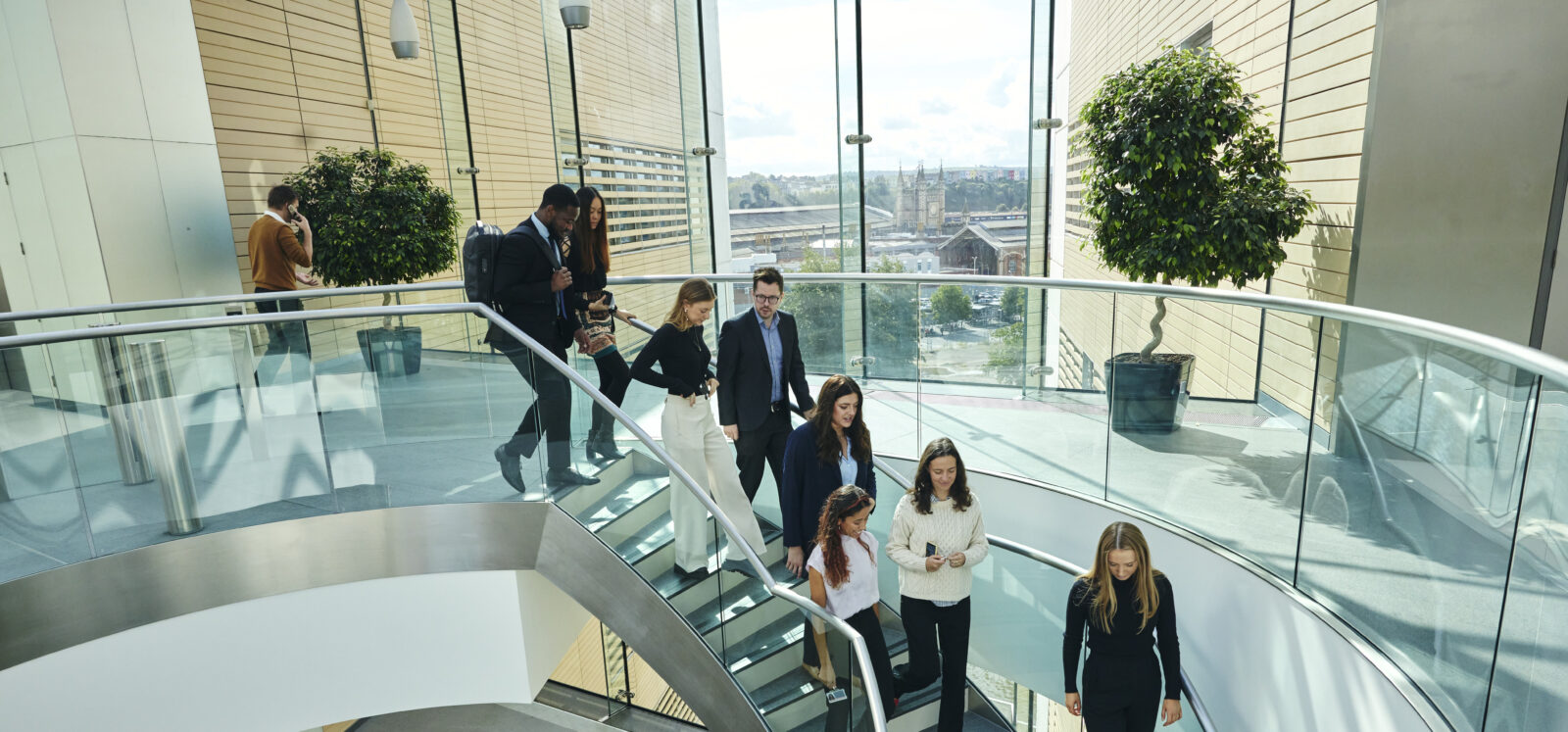 people walking down a spiral staircase