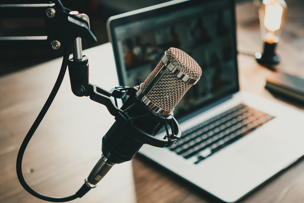 podcast microphone and a laptop