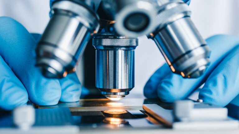 Closeup Shot Of Microscope With Metal Lens At Laboratory