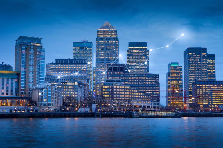 London Canary Wharf skyline at dusk with tech network overlay